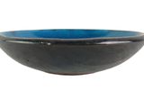 a black and blue bowl sitting on a white surface