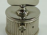 a small silver box with a lid on a white surface