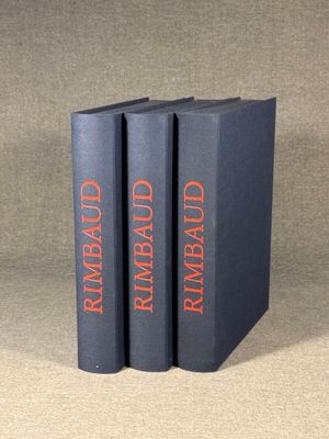 three books are stacked on top of each other on a table