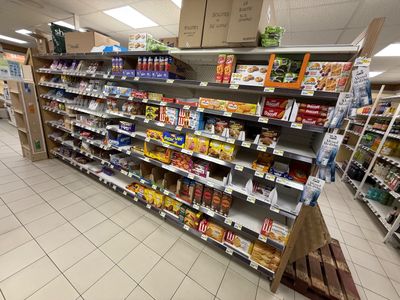 many shelves in the store that have various foods on them