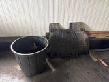 a trash can sitting next to a trash can on the floor