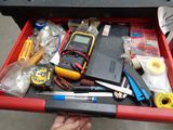someone is holding a tool box filled with tools and a calculator