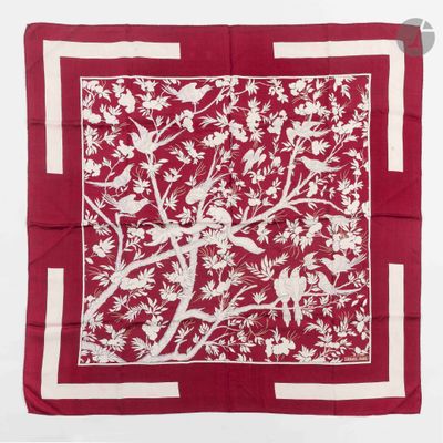 a red and white square scarf with birds and flowers on it