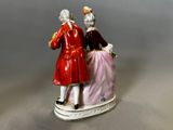 a figurine of a man and a woman on a bench