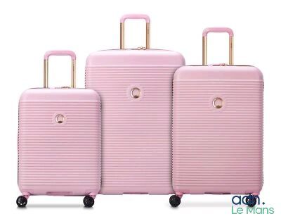 three pieces of pink luggage sitting next to each other on a white surface