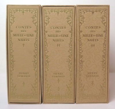 three books are lined up in a row on a white surface