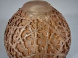 a glass vase with a carved design on it