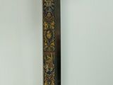 a close up of a sword on a wall with a white background