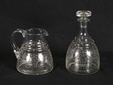 pair of clear glass jugs on a black background with a black background