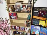 a book shelf with many books on it in a room