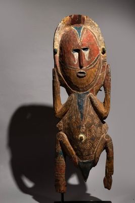 a wooden sculpture of a man with a face and legs