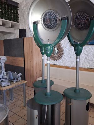 three green blow dryers sitting on top of each other