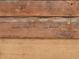 a close up of a piece of wood with writing on it