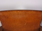 an old wooden chair sitting on top of a wooden table