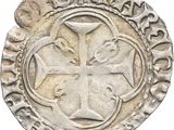 a close up of a coin with a cross on it