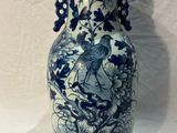 a blue and white vase with a bird on it