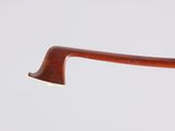 the handle of a wooden stick with a metal tip