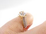 a person holding a ring with a diamond on it