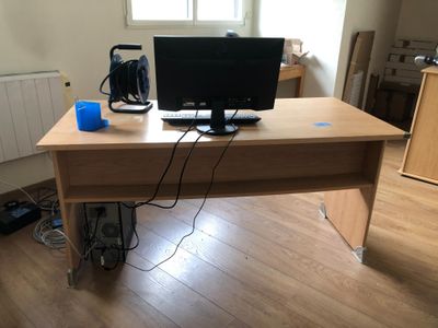 a desk with a computer on it in a room