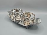 an image of a silver plate with two cups on top of it