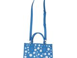 a blue and white polka dot purse with a blue strap