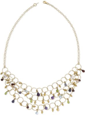 a gold necklace with multi colored stones on a chain