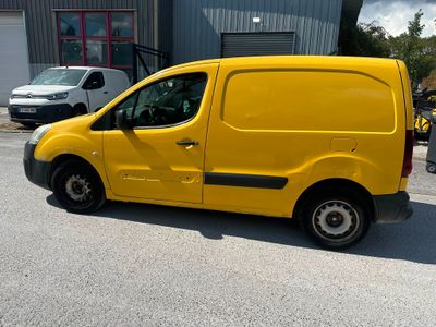 a small yellow van parked in front of a building