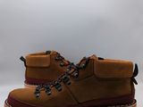 men ' s brown boots with brown soles on a white background