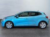 a blue car is parked in a room with a white wall