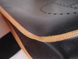 leather handbag with a tan leather strap and a black leather shoulder bag