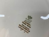 a white plate with a crown on it on a table