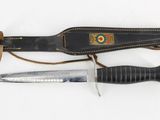 a knife and a sheath on a white surface