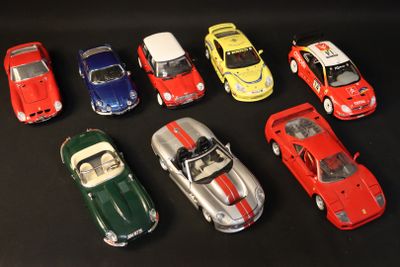 several toy cars are lined up in a row on a black surface