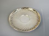 a silver plate with a circular design on it