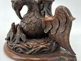 a wooden candle holder with a bird on top of it