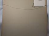 an image of a piece of cardboard with a piece of paper sticking out of it