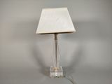 a lamp that is sitting on a table with a white shade