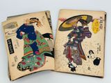 two old books that are open on a white surface