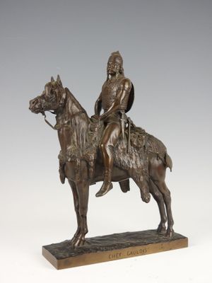 bronze statue of a man on a horse with a shield on his head