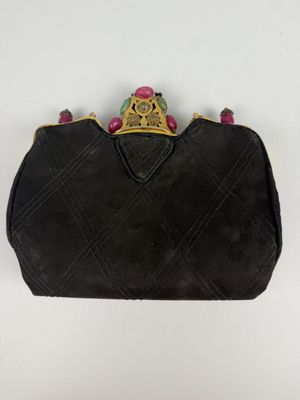 a black purse with a gold crown on top of it