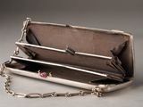 a silver purse that has a chain around it