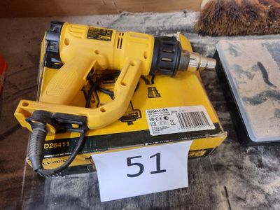 a corded drill and a box of tools on a table