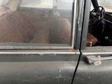 a man that is sitting in a car talking on a cell phone