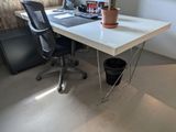 a desk with a chair and a computer on it