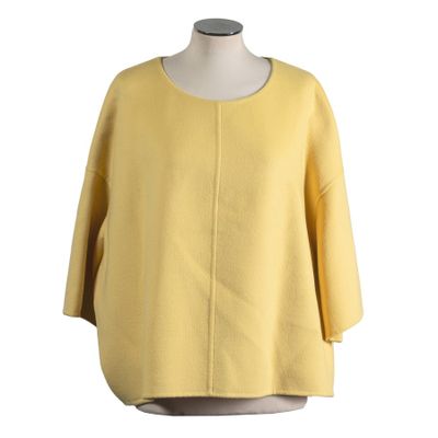 the back view of a yellow sweater with a white collar