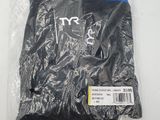 a close up of a bag of black clothing on a white surface