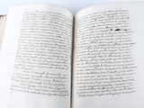 an open book with writing on it sitting on a table