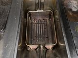 a deep fryer in the middle of a kitchen