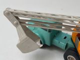 a toy truck with a crane attached to it ' s back