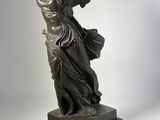 bronze statue of an angel holding a fan on a marble base